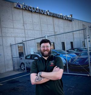 Arapahoe Community College (ACC) alumnus Daniel Girolamo standing in front of ACC's Automotive Technology school