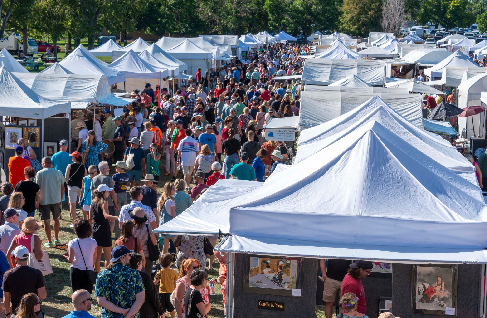 Affordable Arts Festival tents of artists and work and attendees at ACC's Littleton Campus.