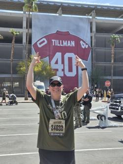 Sue Coons, ACC Fitness Center Facility Coordinator in front of stadium with Tillman jersey in the background