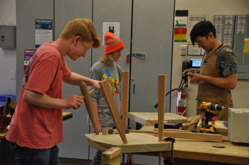 Three students making chairs in ACC's HIVE MakerSpace through Summer Youth Camps.