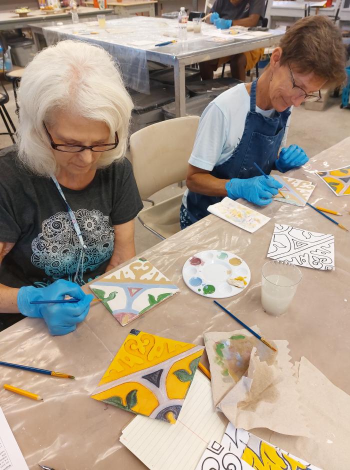 ACC study abroad students painting tiles during trip to Spain and Portugal.