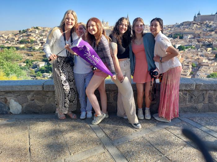 ACC students pose in front of a city during a study abroad trip to Spain and Portugal.