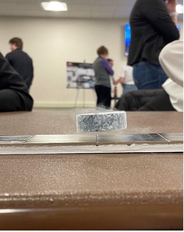 Pictured: Superconductor levitating over the Neodymium magnet track.