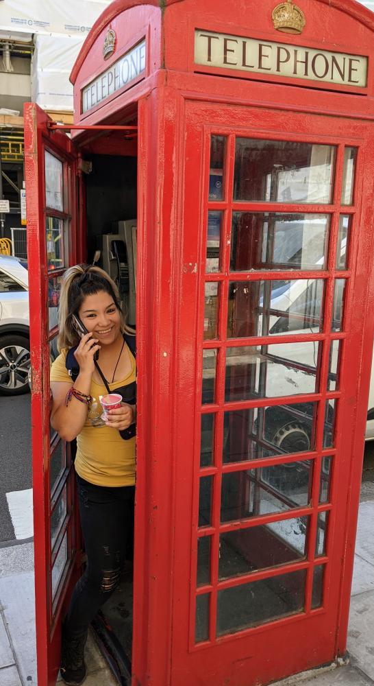 ACC Criminal Justice student posing in English phone booth.