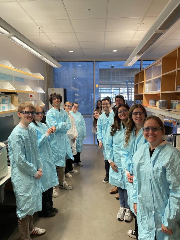 ACC students dressed in scrubs stop for a picture in the CVID building at CSU.