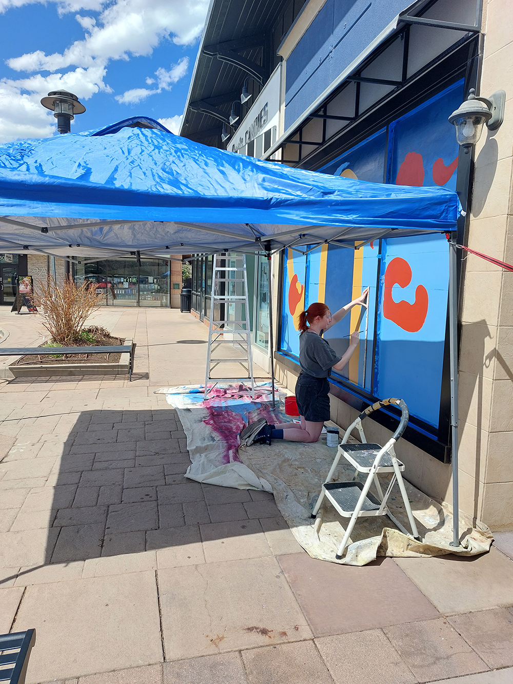 River Hetzel working on the "Light-rail" mural