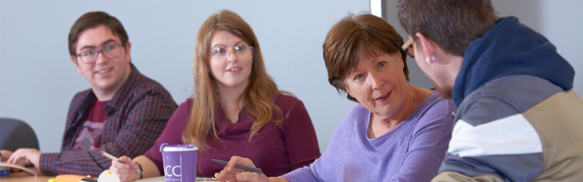 ACC students having a discussion in a classroom at the Littleton Campus.