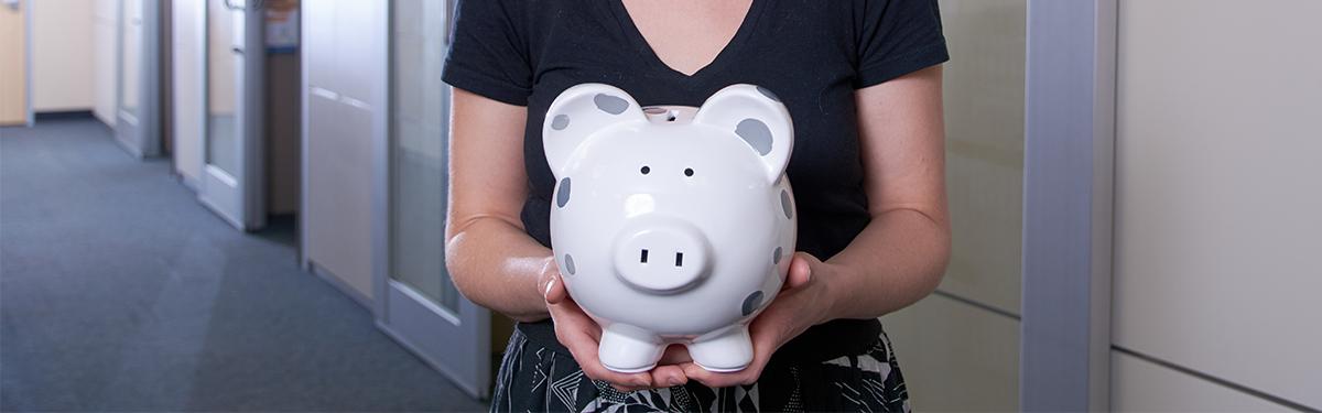 Student holding piggy bank