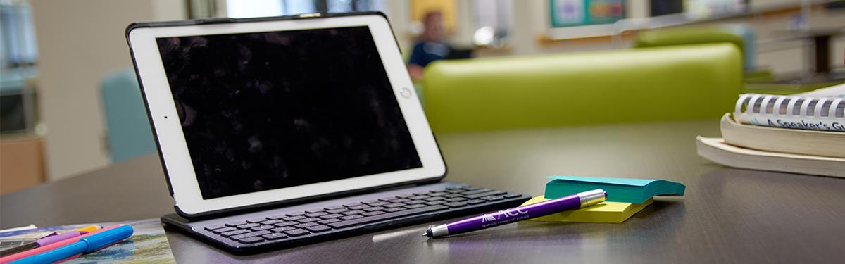 Tablet and supplies on table