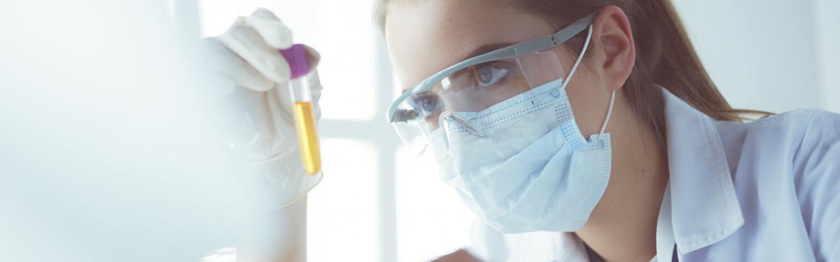 Medical Lab assistant with test tubes in a lab.