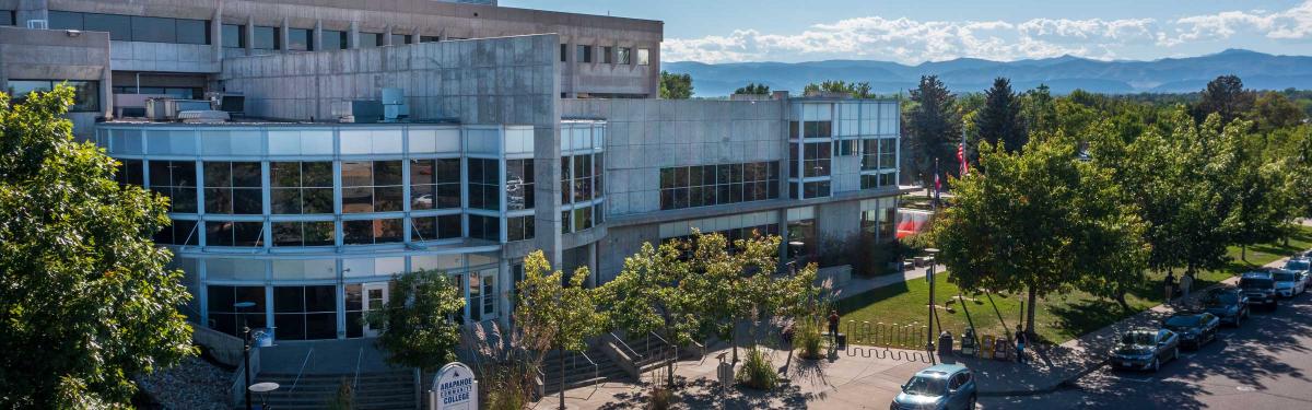 ACC Littleton Campus - Main building main entrance with mountains in the background.