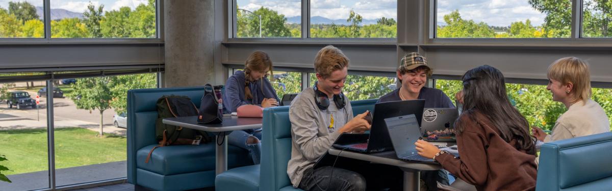 ACC students studying and chatting in the Library & Learning Commons at the Littleton Campus.