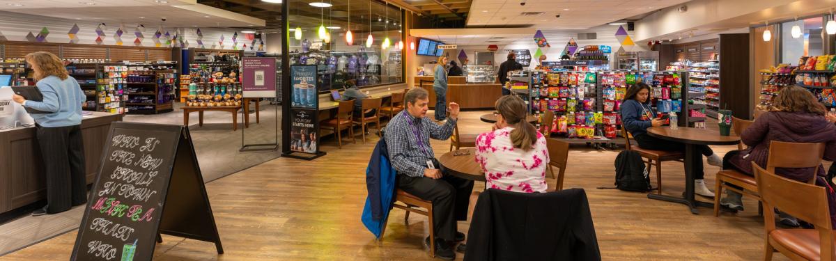 Students sitting at cafe tables inside the Espresso Yourself Cafe at the ACC Littleton Campus.