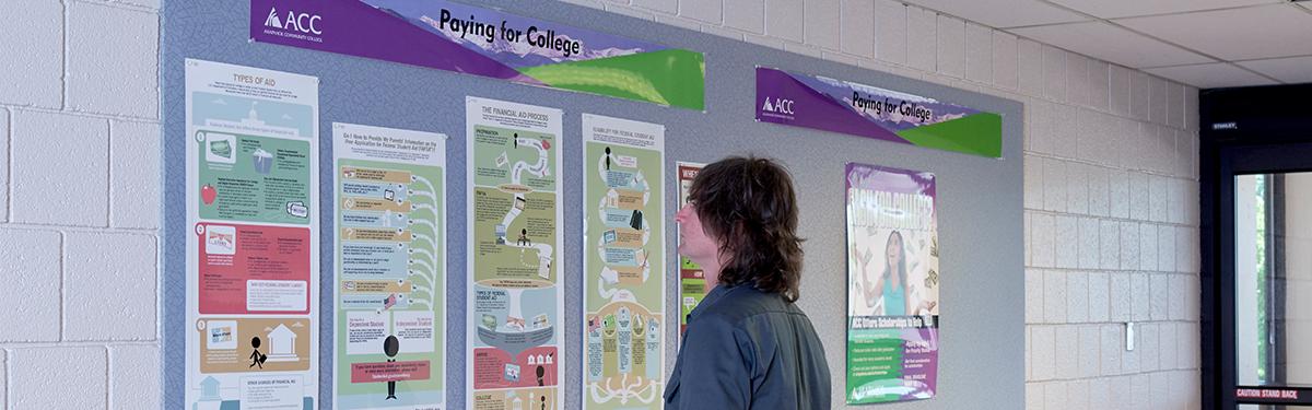 ACC student reviewing Paying for College bulletin board information at the Littleton Campus.