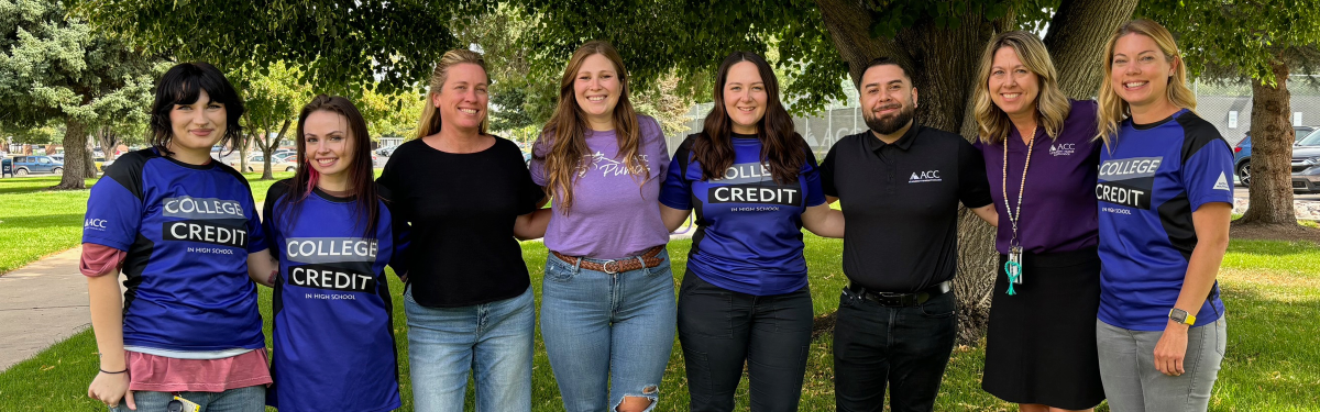 ACC Concurrent Enrollment staff posing in front of trees.