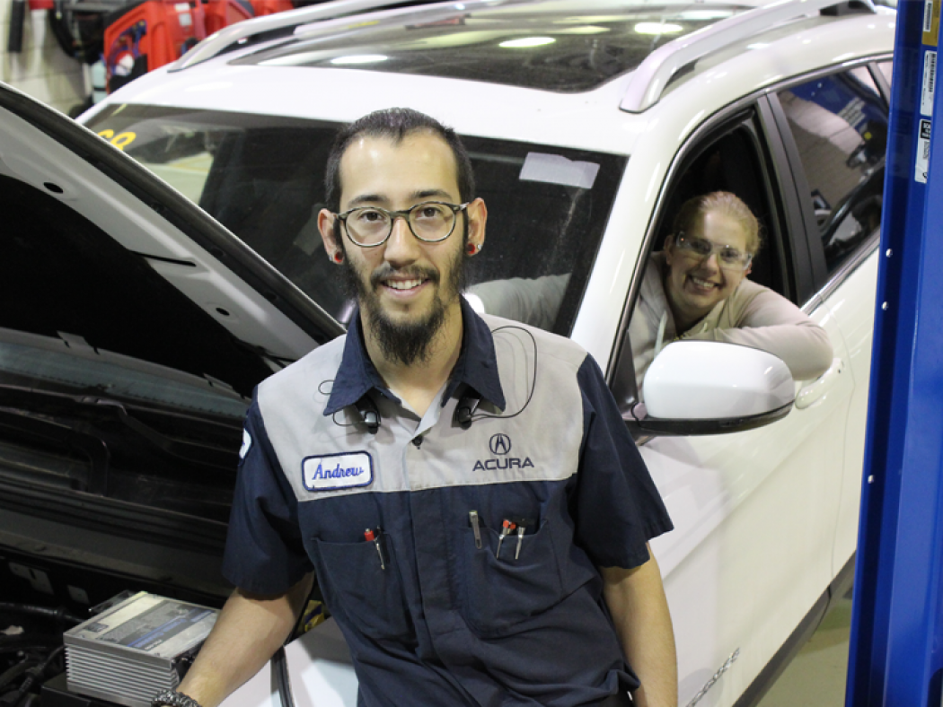 ACC automotive technology students pose will working together on a car in the ACC Auto Tech Shop at the Littleton Campus.