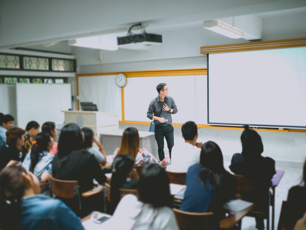 Instructor in front of classroom of students.