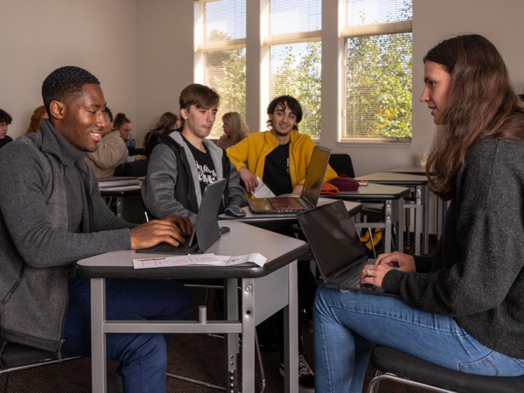 ACC students sitting at desks in a classroom at the Littleton Campus.