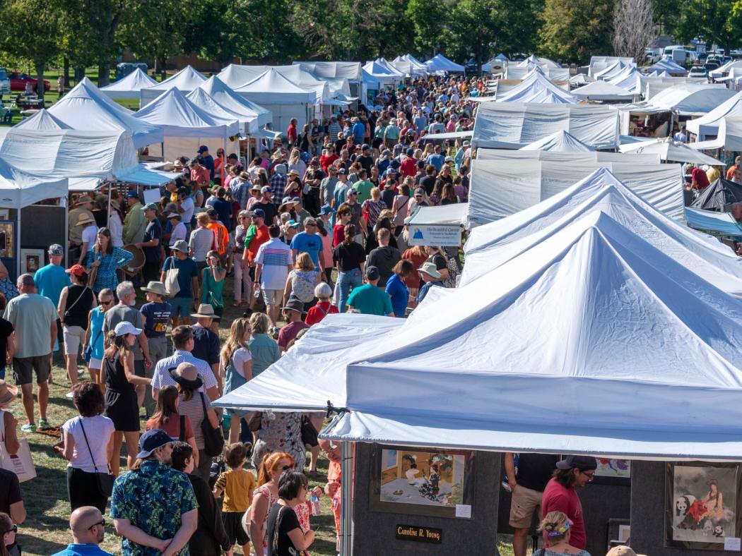 Tents of artists and works surrounded by attendees to the Affordable Arts Festival at ACC's Littleton Campus.