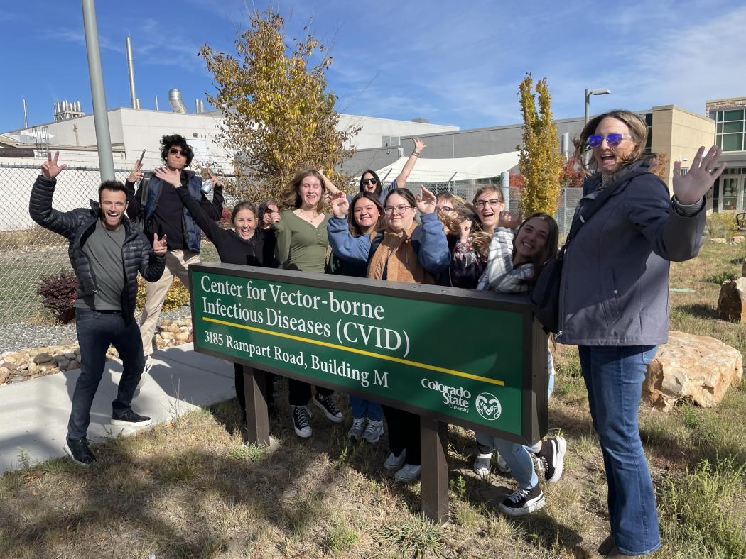 ACC Bio research team of students pose next to Center for Vector-borne Infectious Diseases (CVID) sign at Colorado State University in Fort Collins.