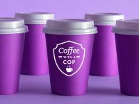 Coffee with a Cop - several purple disposable coffee cups with white lids