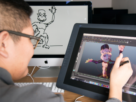 A graphic design student working in the Art and Design Center on the Littleton Campus is animating an illustration of a cartoon monkey. 