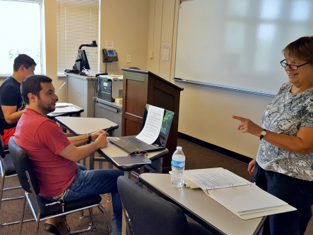 ACC students sitting at desks in a classroom for a Communications course at the Littleton Campus.