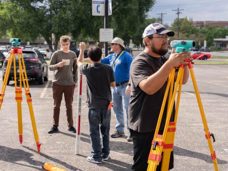 ACC Construction Management students using surveying equipment during classes at ACC's Littleton Campus.