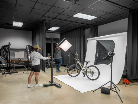 ACC Photography studio overview - backdrop and lights set up with a bicycle being photographed by ACC students - photo by Peter Loyd Vuolo