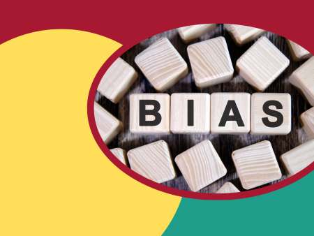 BIAS written on wooden blocks on a colorful background.