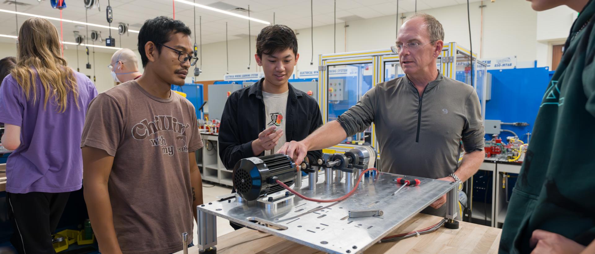 ACC students and faculty member working with robotics technology at the DCSD Legacy Campus.