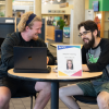 ACC tutor helping another ACC student in the Library and Learning Commons at the Littleton Campus.