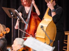 2 ACC students playing cellos in the String Orchestra concert at the Littleton Campus.